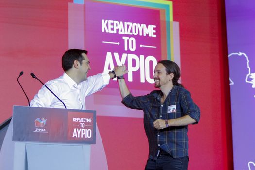 GREECE, Athens: Alexis Tsipras, Syriza leader and former Prime Minister, high-fives Pablo Iglesias, the leader of the Spanish anti-austerity Podemos party, during the Syriza party's final election rally at Syntagma Square, Athens on September 18, 2015 two days ahead of the Greek General Election