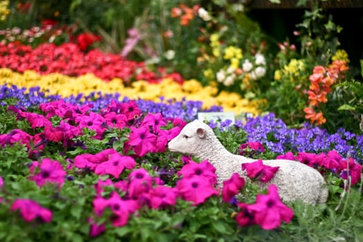 Flowers with a sheep statue and blur background