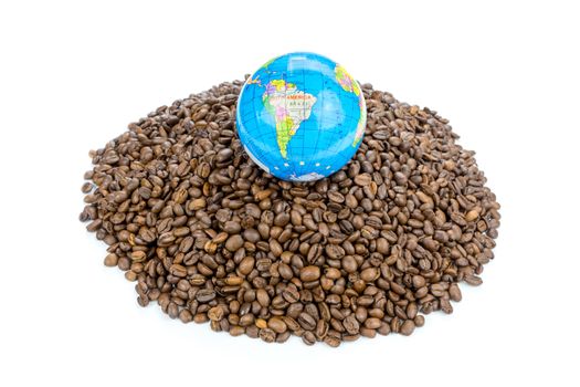 Little globe with earth on heap of whole coffee beans isolated on white background