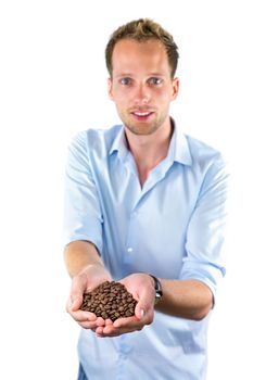 Young salesman showing hands full with coffee beans isolated on white background