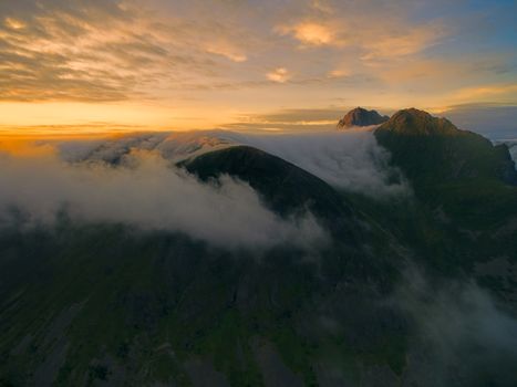 Clouds crawling over the magnificent peaks on Lofoten islands in Norway