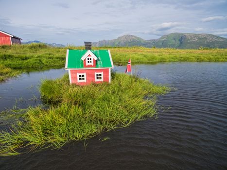 Aerial view of miniature norwegian house on lake
