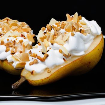 pears with whipped cream sprinkled   nuts and almonds