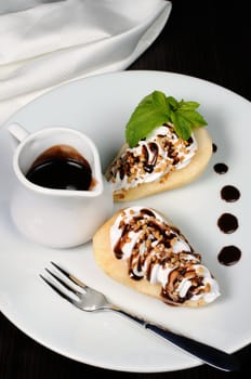 pears with whipped cream sprinkled   nuts,  almonds and chocolate