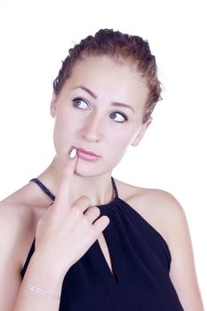 Portrait of pensive young woman asking a question to herself while looking at you on isolated studio.