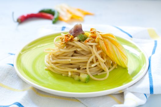 Spaghetti with marinated anchovy, zucchini and zucchini flowers