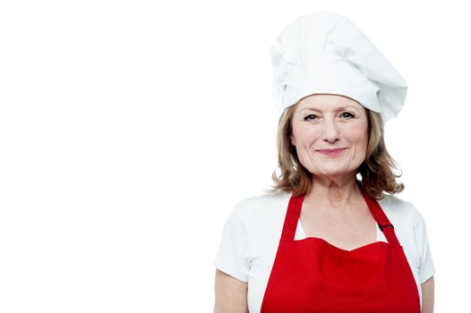 Happy mature female chef posing over white