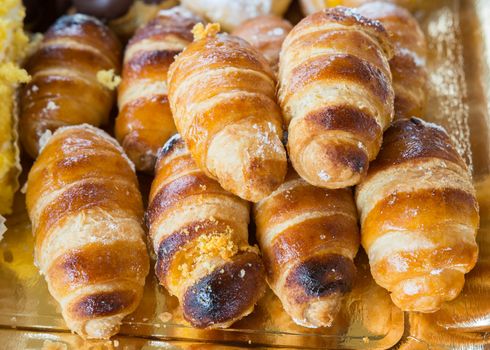 Italian cream horn pastries on decorative plate.