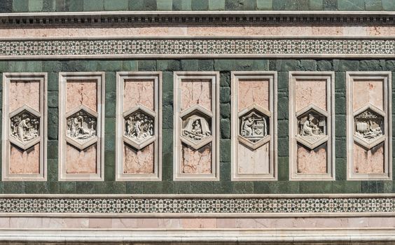 In the picture detail of the Basilica of Santa Maria del Fiore in Florence, a patterns of rectangular statues symmetrical.