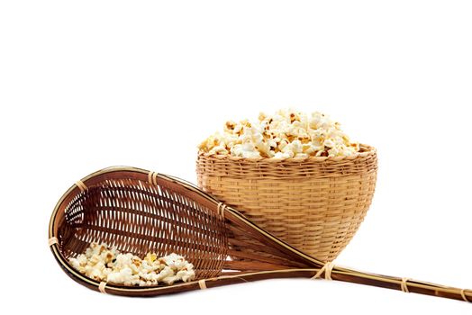 Popcorn in a wooden bucket on white background