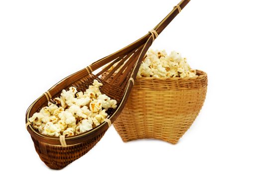 Popcorn in a wooden bucket on white background