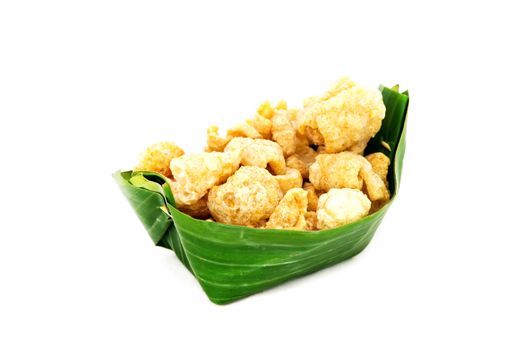 Thai Food appetizer ,Pork snack, pork rind, pork scratching, pork crackling in banana leaf bowl.