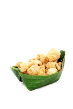 Thai Food appetizer ,Pork snack, pork rind, pork scratching, pork crackling in banana leaf bowl.