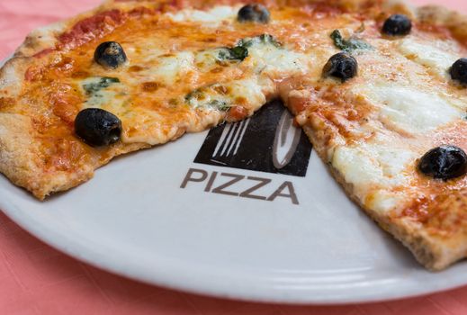 Pictured wheat pizza with olives tomato basil and mozzarella Neapolitan (bufala)