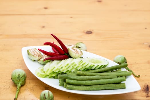 seasonal vegetables in a dish isolated on a white background