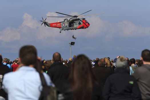 ENGLAND, Southport: A man rappels from a Royal Navy Rescue helicopter during the Southport Airshow 2015 in Southport, Merseyside in England on September 19, 2015