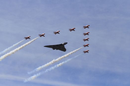 ENGLAND, Southport: The Red Arrows take their final formation flight with a Vulcan bomber during the Southport Airshow 2015 in Southport, Merseyside in England on September 19, 2015