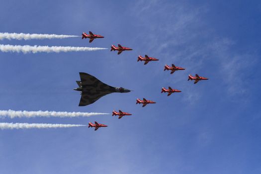 ENGLAND, Southport: The Red Arrows take their final formation flight with a Vulcan bomber during the Southport Airshow 2015 in Southport, Merseyside in England on September 19, 2015