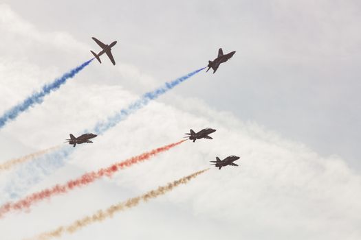 ENGLAND, Southport: Red Arrows fly in formation spewing coloured smoke during the Southport Airshow 2015 in Southport, Merseyside in England on September 19, 2015