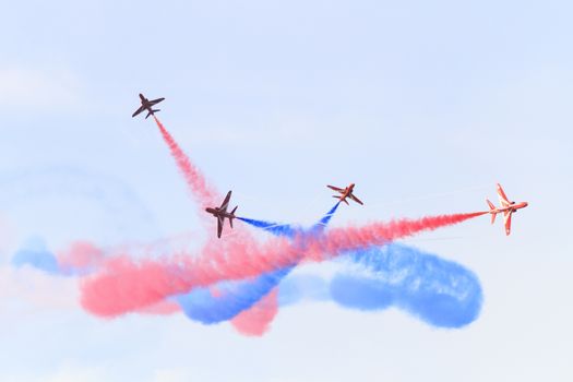 ENGLAND, Southport: Red Arrows fly in all directions leaving a colourful smoke pattern during the Southport Airshow 2015 in Southport, Merseyside in England on September 19, 2015