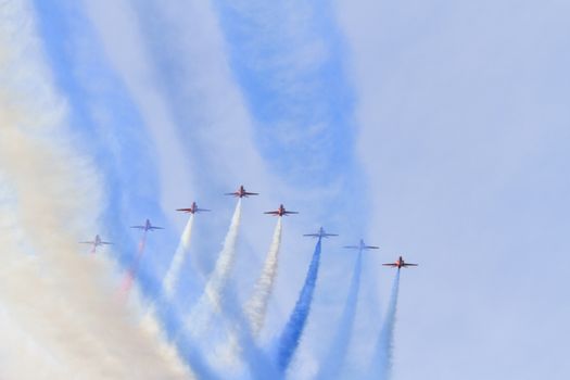 ENGLAND, Southport: Red Arrows fly in formation leaving coloured smoke trails during the Southport Airshow 2015 in Southport, Merseyside in England on September 19, 2015