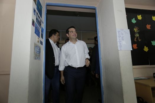 GREECE, Athens: Leader of left-wing party Syriza and former Prime minister Alexis Tsipras enters the polling station in Athens on September 20, 2015 during Greek General Election first row. The election is the second Greek General Election within a year.