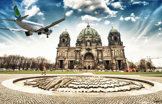 Airplane overflying Berlin Cathedral.