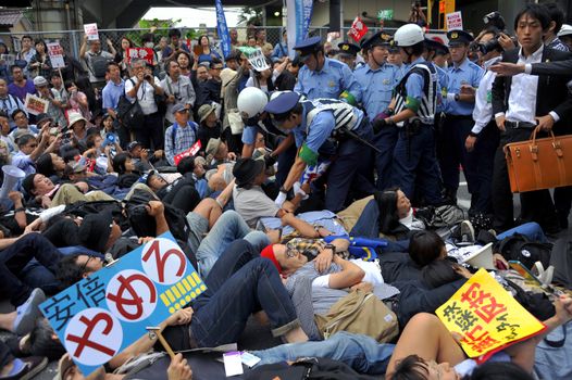 JAPAN, Yokohama: Protestors hold a die-in in Yokohama, Japan, on September 16, 2015 during a demonstration against security law. Demonstrators claim Japanese Prime minister Shinzo Abe's resignation.