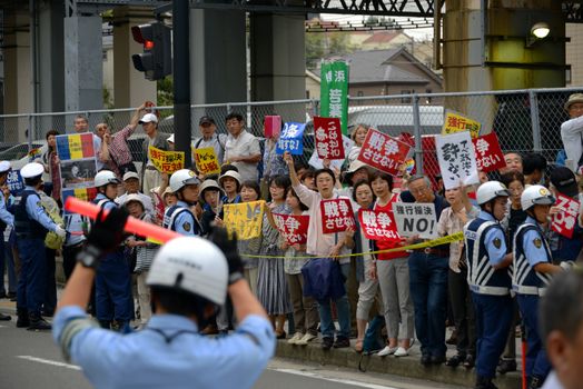 JAPAN, Yokohama: Protestors hold signs in Yokohama, Japan, on September 16, 2015 during a demonstration against security law. Demonstrators claim Japanese Prime minister Shinzo Abe's resignation.
