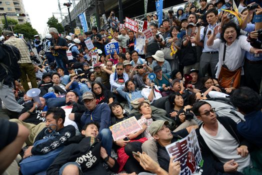 JAPAN, Yokohama: Protestors hold a die-in in Yokohama, Japan, on September 16, 2015 during a demonstration against security law. Demonstrators claim Japanese Prime minister Shinzo Abe's resignation.