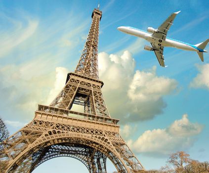 Airplane overflying Eiffel Tower in Paris.