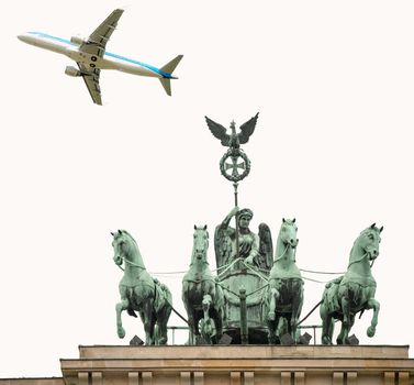 Airplane overflying Berlin Quadriga over Brandenburg Gate.