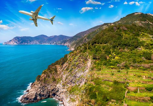 Airplane overflying beautiful coastline.