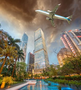 Airplane overflying Hong Kong financial district.