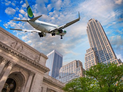 Airplane overflying Public Library and Fifth Avenue in New York.