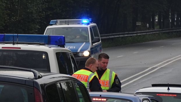 AUSTRIA, Saalachbruecke: Hundreds of migrants wait in cold and rainy weather at the border in Austria hoping to cross into the town of Freilassing in Germany on September 20, 2015.  Many migrants are seeking asylum in either Germany or Sweden, but those countries are calling on their EU partners to show solidarity and share the responsibility. 	