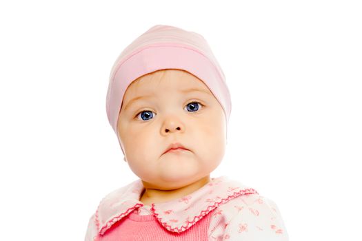 Portrait of a serious baby in a pink hat on a white background