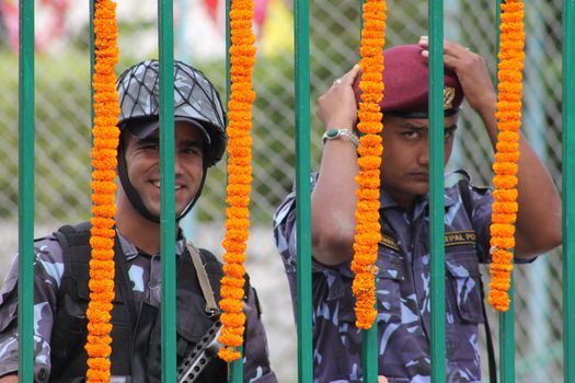NEPAL, Kathmandu: A soldier smiles as Nepal celebrates a new constitution embracing the principles of republicanism, federalism, secularism, and inclusiveness, in Kathmandu on September 20, 2015. Out of the 598 members of the Constituent Assembly, 507 voted for the new constitution, 25 voted against, and 66 abstained in a vote on September 16, 2015. The event was marked with protests organized by parties of the Tharu and Madhesi ethnic communities, which according to Newzulu contributor Anish Gujarel led to violence in Southern Nepal.