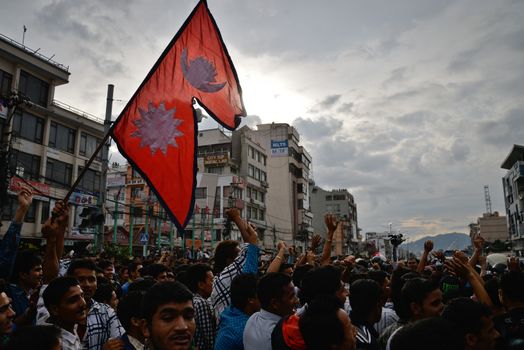 NEPAL, Kathmandu: After years of debate, Nepal adopted a new constitution on September 20, 2015, prompting scores of residents to celebrate near the constituent assembly building in Kathmandu. Out of the 598 members of the Constituent Assembly, 507 voted for the new constitution, 25 voted against, and 66 abstained in a vote on September 16, 2015. The event was marked with protests organized by parties of the Tharu and Madhesi ethnic communities, which according to Newzulu contributor Anish Gujarel led to violence in Southern Nepal.