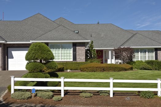 Large home with white fences and manicured lawn Oregon.