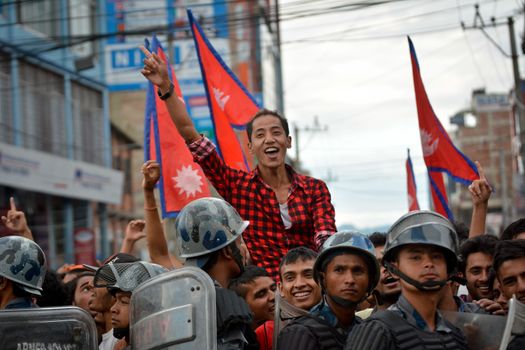 NEPAL, Kathmandu: After years of debate, Nepal adopted a new constitution on September 20, 2015, prompting scores of residents to celebrate near the constituent assembly building in Kathmandu. Out of the 598 members of the Constituent Assembly, 507 voted for the new constitution, 25 voted against, and 66 abstained in a vote on September 16, 2015. The event was marked with protests organized by parties of the Tharu and Madhesi ethnic communities, which according to Newzulu contributor Anish Gujarel led to violence in Southern Nepal.