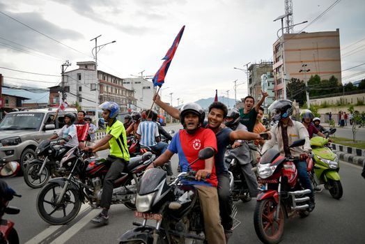 NEPAL, Kathmandu: After years of debate, Nepal adopted a new constitution on September 20, 2015, prompting scores of residents to celebrate near the constituent assembly building in Kathmandu. Out of the 598 members of the Constituent Assembly, 507 voted for the new constitution, 25 voted against, and 66 abstained in a vote on September 16, 2015. The event was marked with protests organized by parties of the Tharu and Madhesi ethnic communities, which according to Newzulu contributor Anish Gujarel led to violence in Southern Nepal.