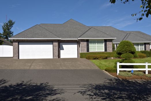 Large home with white fences and manicured lawn Oregon.