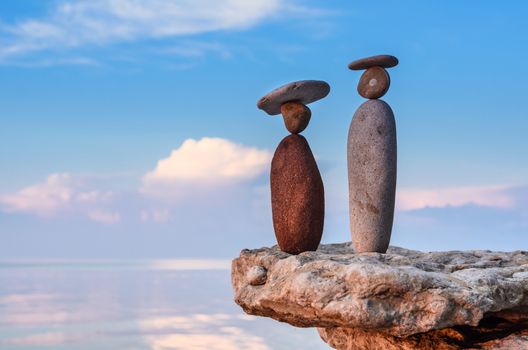 Symbolic image of man and woman of the stones on the seashore