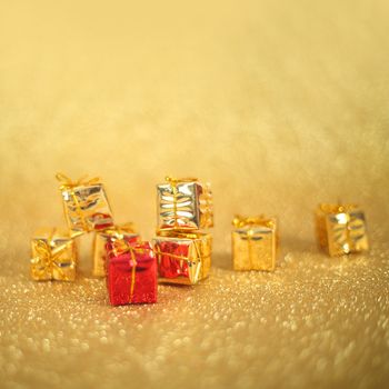 Holiday gift boxes on shiny golden background with copy space