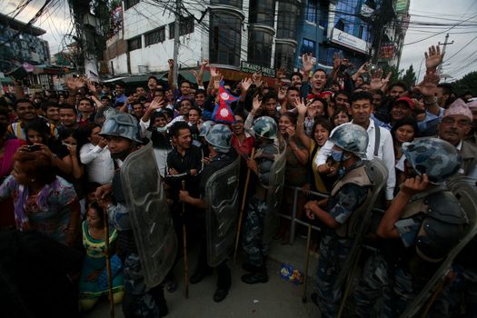 NEPAL, Kathmandu: After years of debate, Nepal adopted a new constitution on September 20, 2015, prompting scores of residents to celebrate near the constituent assembly building in Kathmandu. Out of the 598 members of the Constituent Assembly, 507 voted for the new constitution, 25 voted against, and 66 abstained in a vote on September 16, 2015. The event was marked with fireworks and fesitivities, but also with protests organized by parties of the Tharu and Madhesi ethnic communities.