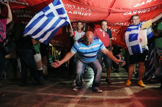 GREECE, Athens: Supporters of Syriza leader Alexis Tsipras celebrate in Athens after he claimed victory in Greece's parliamentary election on September 20, 2015. The leftist party plans to form a coalition government with the small right-wing Independent Greeks party after defeating its main rival, the conservative New Democracy party, with an early figure of 35.46 per cent of the vote. 