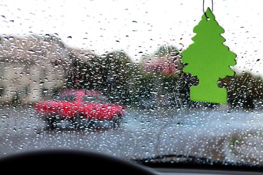 dashboard and rain droplets, car's ventilation system with an air freshener on it