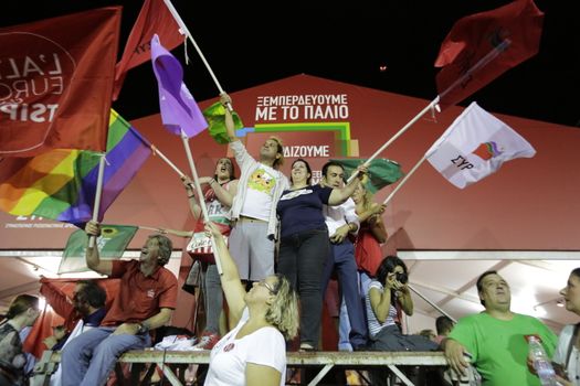 GREECE, Athens: Syriza supporters wave flags as Syriza leader Alexis Tsipras addressed supporters in Athens after claiming victory in Greece's parliamentary election on September 20, 2015.