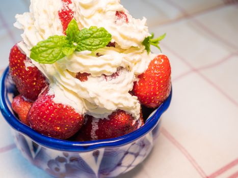 Strawberry wuth whipped cream in traditional russian plate - gzhel